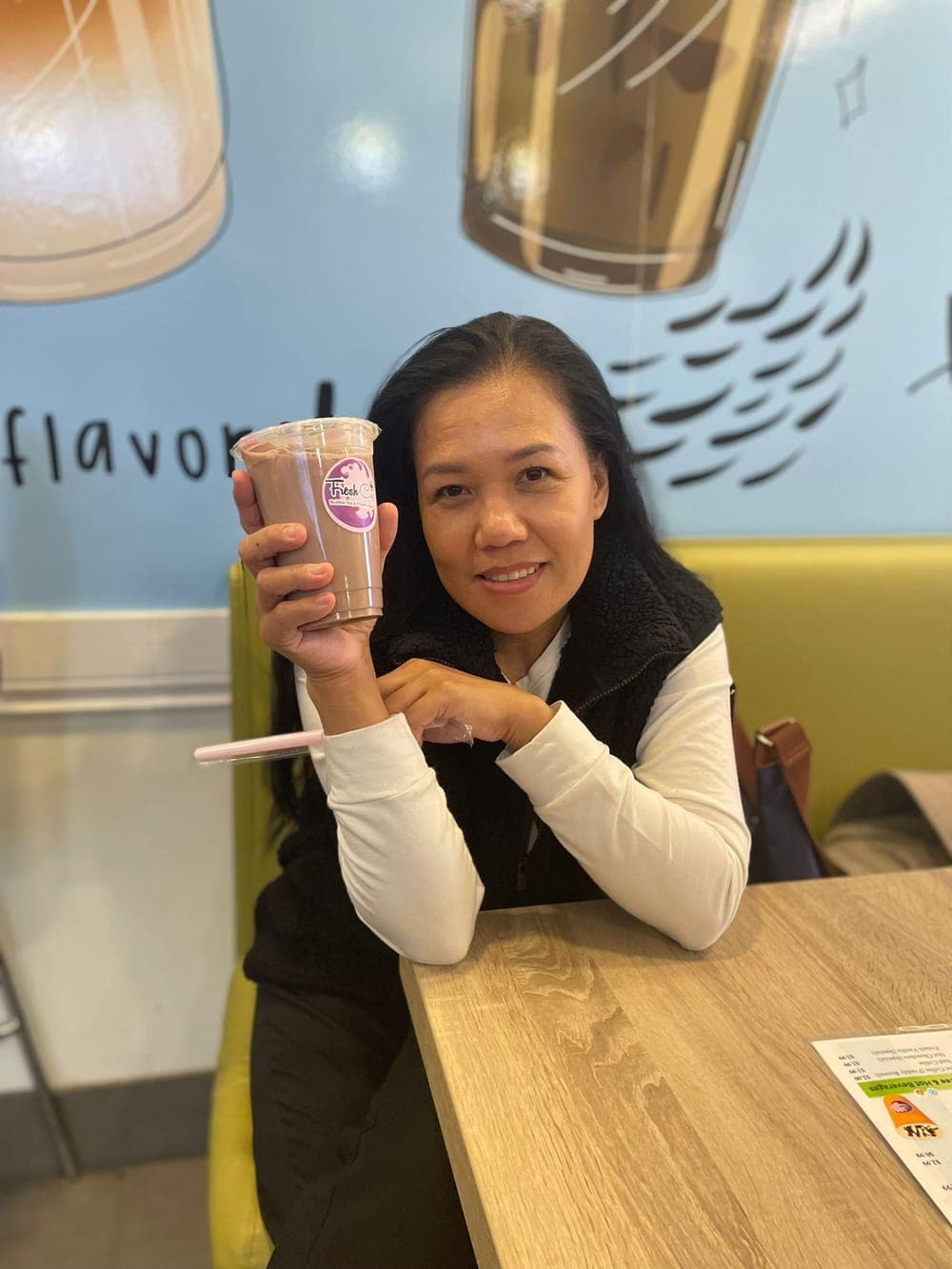 Smiling Fresh Cup customer enjoying a fresh drink in our Don Mills cafe