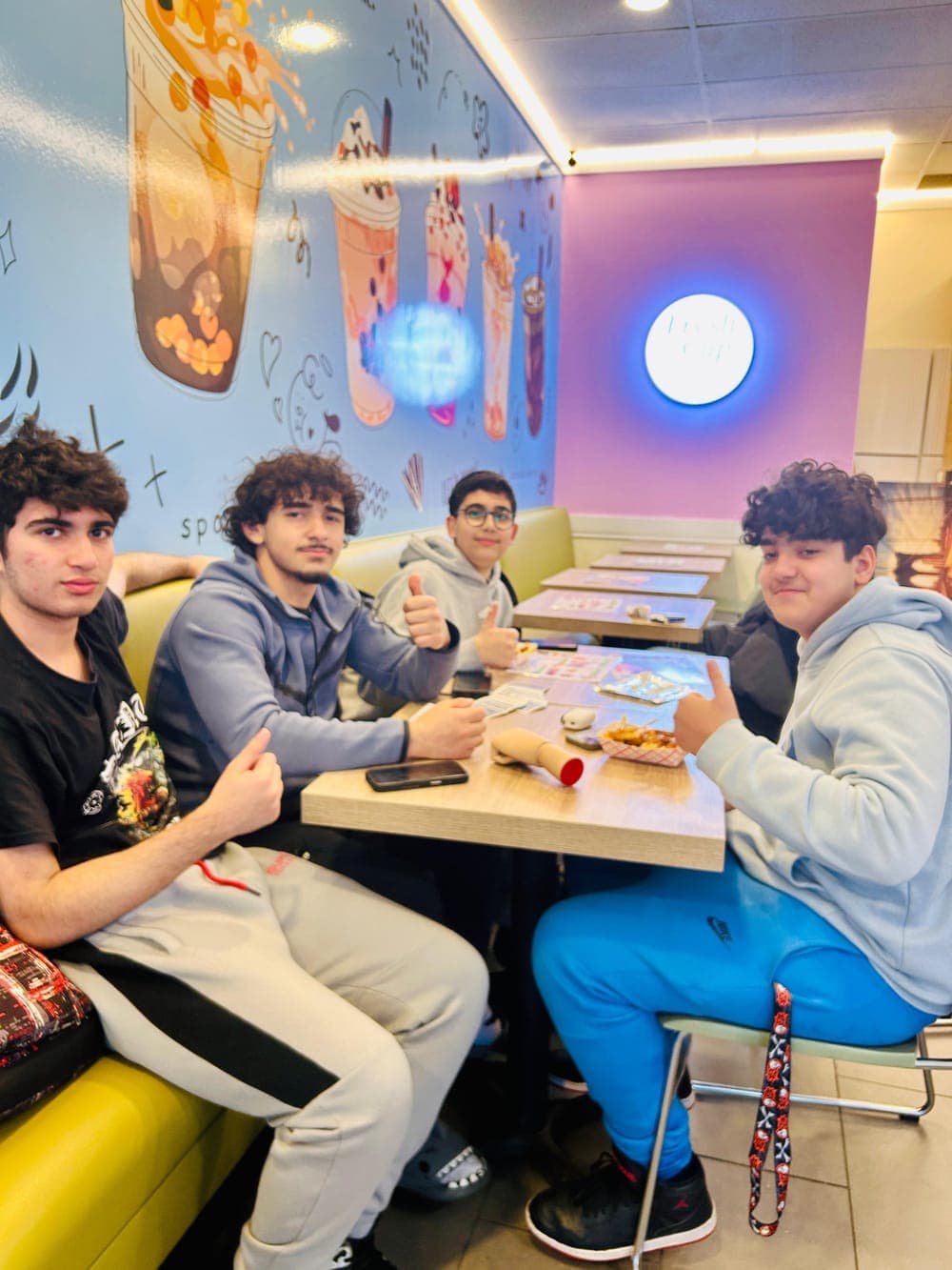Group of friends hanging out with drinks at Fresh Cup